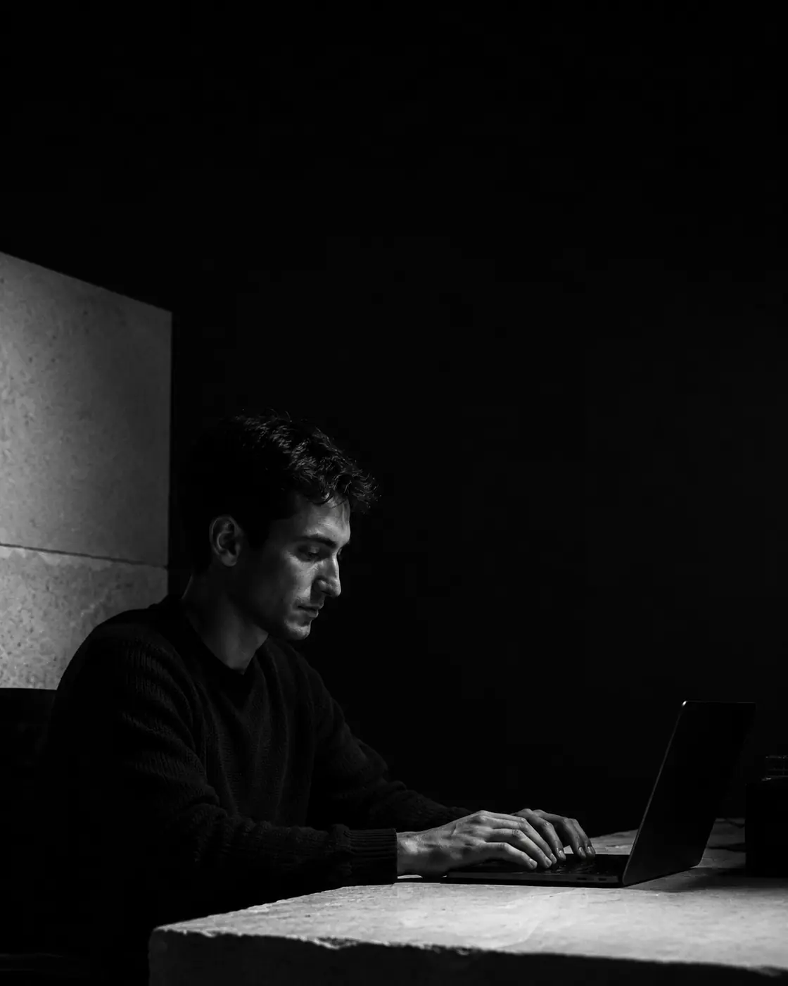 Conceptual portrait of a software maker working at a laptop